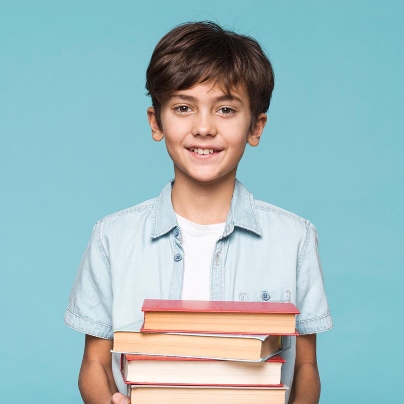 smiley-boy-holding-stack-books